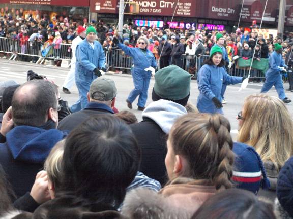 Spartan handles Macy’s balloons Scott Dunn (far left in blue jumpsuit and green hat) and Dorothy Gergely (with sunglasses and no hat) march along on the crew of the Planet Earth balloon during the Macy’s Thanksgiving Day Parade Thursday,