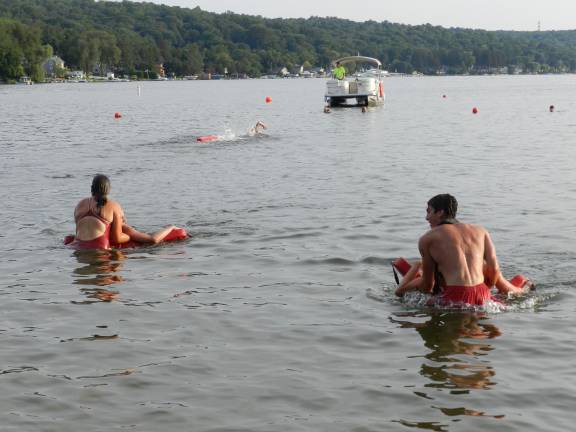 Olivia Maute pulls in victim Colin Hamilton from White Meadow Lake against Thomas Flake and his victim in the Rescue Tube Relay.