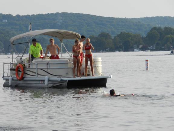 Victims getting ready to jump in for the Rescue Tube Relay from the Lake Mohawk Marine Patrol boat.