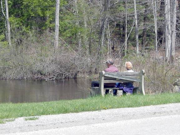 A couple enjoys the quiet and solitude brookside at Wawayanda State Park in Sussex County, N.J. New Jersey re-opened parks and private golf courses on Saturday.