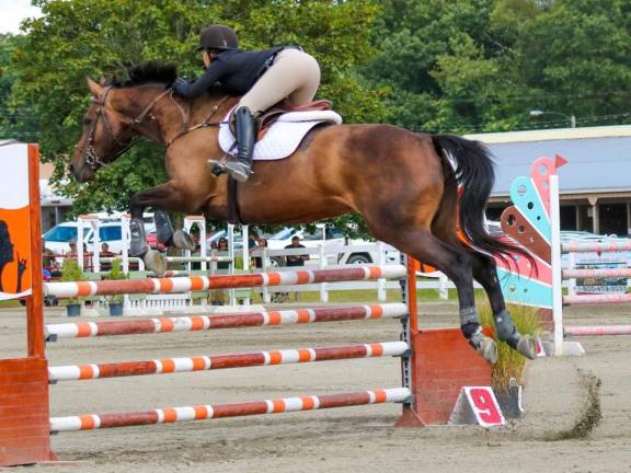 Magnificent jump through the air, over the obstacle in Sunday's Aug. 11, 2019 competition at the State Farm and Horse Show in Augusta.