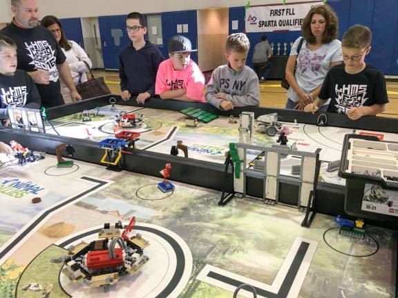 Vernon students watching their robot in action on the field
