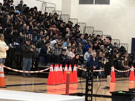 One of the tournament officials explains the rules to students competing in the tournament.