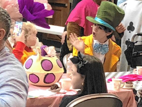 Photos: Mad Hatter’s Tea Party The Mad Hatter greets a guest at the Mad Hatter’s Tea Party on Saturday, Jan. 18 in the Sparta High School auditorium. The event was a meet and greet as well as a performance by the cast of the middle school musical ‘Alice in Wonderland Jr.’<b> </b>(Photos by Kathy Shwiff)