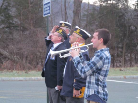 Veterans bring history alive for high school students Luke Giugliano plays Taps while veterans salute