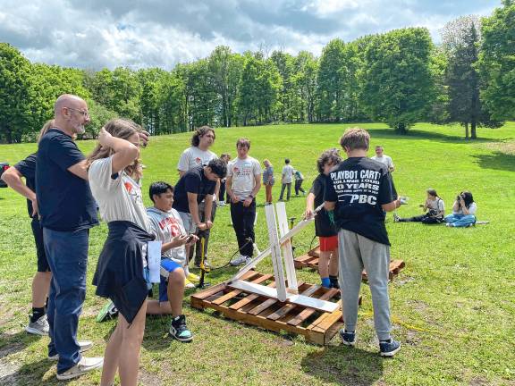 Students build water rockets ST3 Hardyston Middle School competitors and high school assistants, from left, Emily Guarino, Isaiah Gutierrez, Kaleb Billegas, John Ozdemir, Noah DeRenzo, Jovanni Portilla and Alekos Reinlee prepare their launcher for final testing.