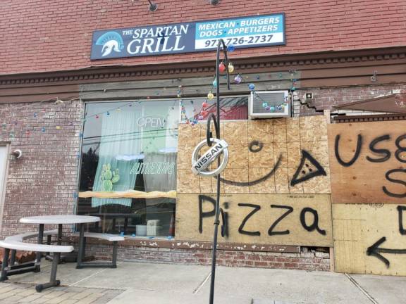 A Friday night motor vehicle accident leaves a restaurant front window and brick wall in disrepair.