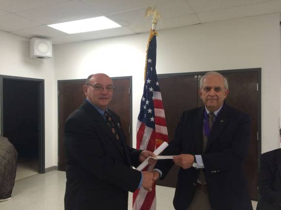 Knights donate to help VFW Sparta VFW Commander Pete Litchfield, left, accepts donation check from St. Kateri Grand Knight Jim Brocato.