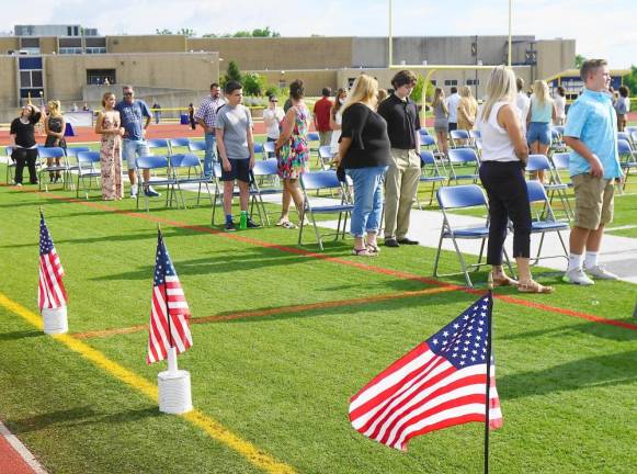 Parents and students stand for The Star Spangled Banner. (Photo by Vera Olinski)