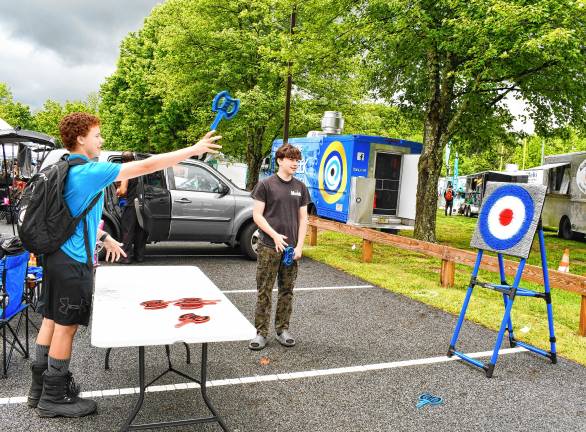 Township celebration marks 50th year Matthieu Patterson of Sparta throws an ax at a target at Sparta Day. (Photos by Maria Kovic)