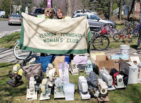 Woman’s Club wins national recognition for sewing machine drive International Committee chair Karen Rothstadt (left) and communications chair Lisa Mills display their club banner with many of the 58 sewing machines collected during the 2019 project (Photo provided)