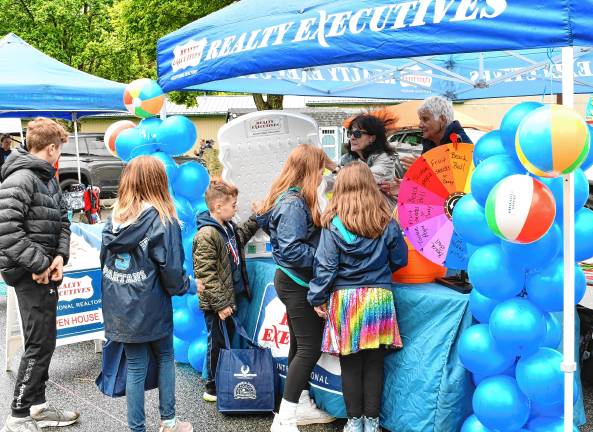 Township celebration marks 50th year Children wait for balloons at a booth.