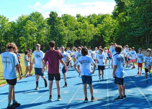 Sparta Track and Field Camp Campers stretch before beginning practice.