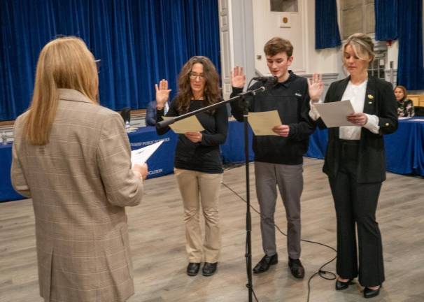 SSB1 Joanne Black swears in, from left, Jennifer Lonsky, Chad Wood and Kaitlin Gagnon as new members of the Sparta Township Board of Education on Thursday, Jan. 4. (Photos by Nancy Madacsi)