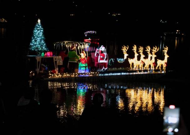 LM1 Santa and Mrs. Claus, an elf and reindeer ride on a barge on Lake Mohawk on Sunday, Dec. 3. The barge was designed by Caruso Lakeshore Construction &amp; Services. (Photos by Nancy Madacsi)