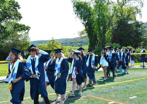 Photos: Sparta High School graduation Graduates hold on to the caps on the windy day.