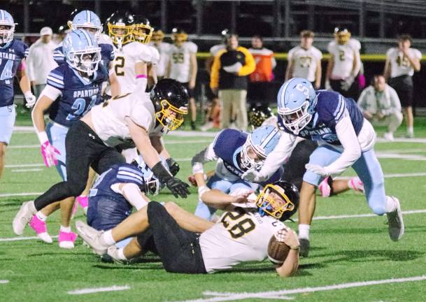 Highlanders rout Spartans, 31-0 West Milford ball carrier Jeffrey Papienuk lands on the turf after being tackled by Sparta defenders in the first half. Papienuk scored three rushing touchdowns in the game.
