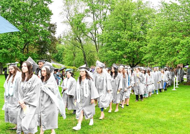 A touch of adversity Graduates walk into the ceremony.