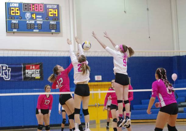 Pope john bests Jefferson in volleyball Jefferson's Audrey Oostdyk (12) gets a hand on the ball as Pope John defenders react by leaping above the net in the final match. Oostdyk accomplished one service point, four kills and one dig.