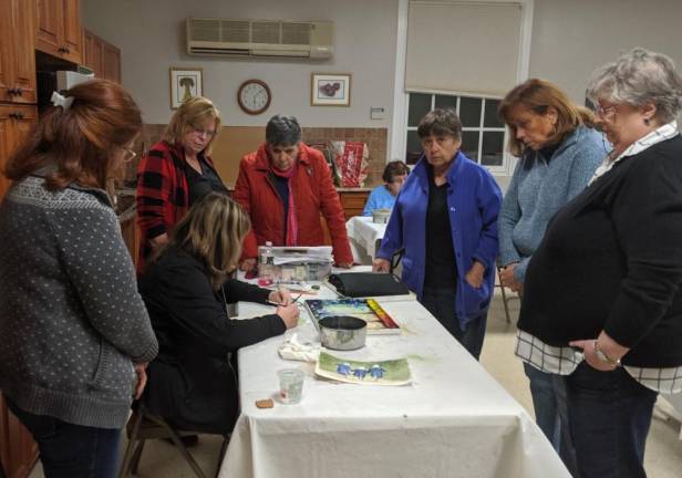 Art class feels like an oasis Class members gather around artist Toni Chaplin as she demonstrates painting technique in Art class in Sparta on Thursday, Nov. 7, 2019. The class members say they have found that the weekly lessons bring camaraderie, good humor, and excellent teaching.