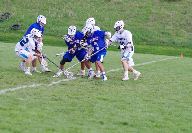 Spartans top Blue devils in boys lacrosse Sparta Spartans and Westfield Blue Devils clash for control of the ball. Photos by George Leroy Hunter