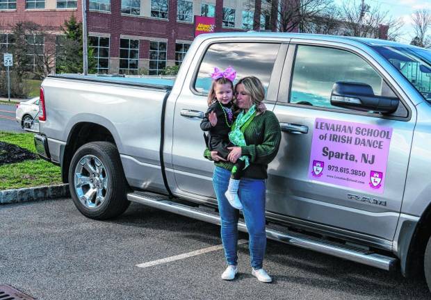Maggie and Hailey Meger stand by the Lenahan School of Irish Dance truck.