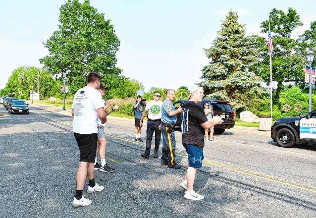 Photos: Law Enforcement Torch Run People applaud as the runners arrive in Sparta.
