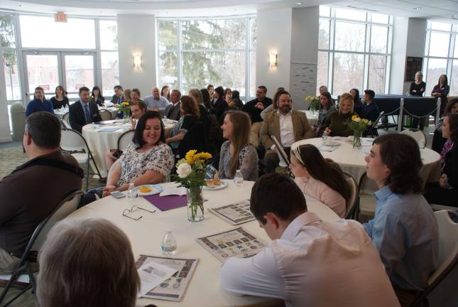 Brunch attendees give a round of applause for the scholar athlete nominees.
