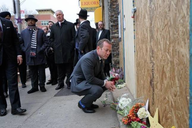 U.S. Rep. Gottheimer pays respects outside JC Kosher Deli, the site of last week’s deadly anti-Semitic attacks in Jersey City.