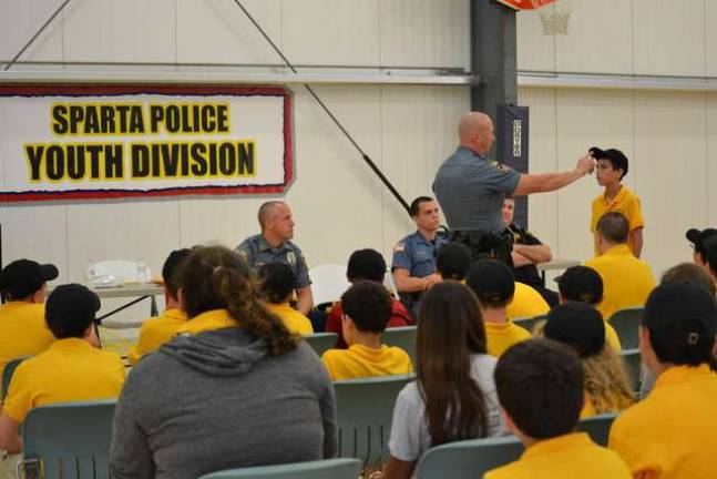 Sparta Police Cpl. Brian Hassloch, a Certified Drug Recognition Expert, demonstrates field sobriety tests at last summer's Sparta Police Youth Division's Junior Police Academy. photos provided by the Sparta Police Department