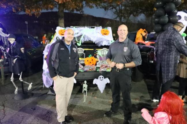 Sparta police Officers Chris Favaro and Brian Hassloch pose at the Trunk or Treat.