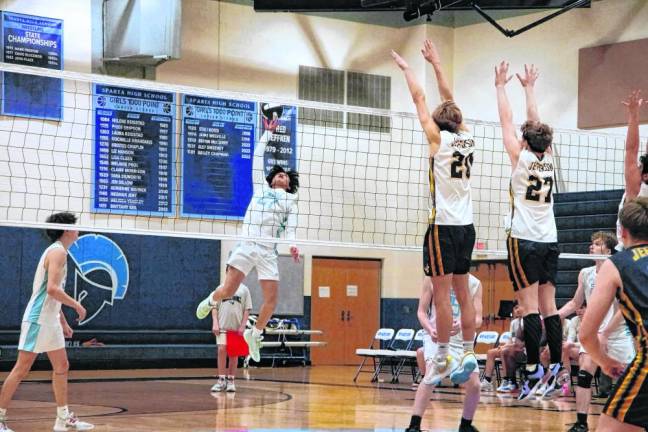 Sparta's Joshua Tolentino gets a hand on the ball to strike it in the match against Jefferson at home Thursday, April 11. The Spartans lost, 25-18, 25-19. (Photos by George Leroy Hunter)