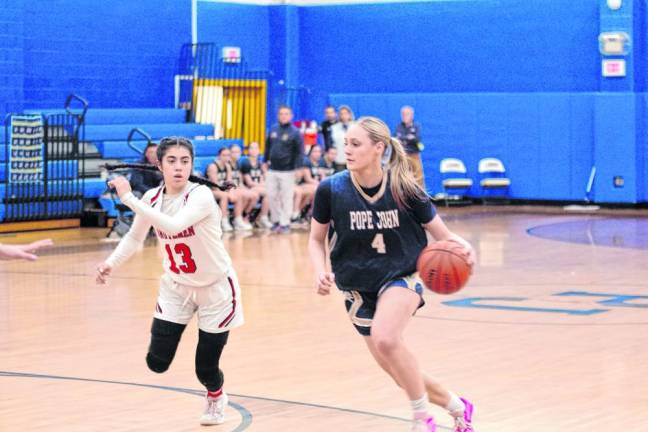 Pope John's Addison Platt dribbles the ball past Newark Academy's Dagny Slomack. Platt scored 18 points. (Photo by George Leroy Hunter)