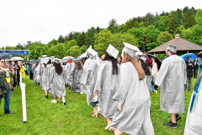 A touch of adversity Graduates pose for photos during the procession.