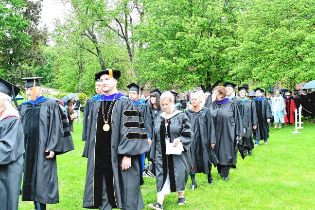 A touch of adversity Cory Homer, second from left, SCCC’s interim president, walks into the commencement ceremony with faculty members.