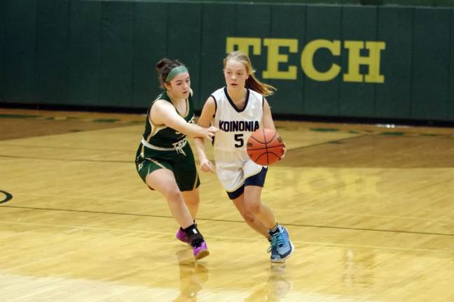 Koinonia's Gwen Niemeyer handles the ball while covered by Sussex Tech's Teagan Smith.