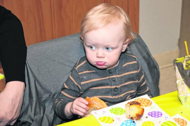 Phil Wiltz, 1, eats breakfast with his family.