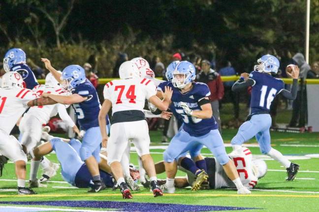 Freshman quarterback Austen Frattura pulls back to throw the ball while fellow Spartans hold off the knights.