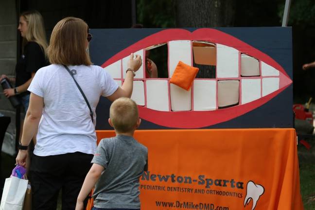 A mom and child try the bean bag toss. There were lots of fun things to do and see at this year's Sparta Day. (Photos by Shannon Kuratli)