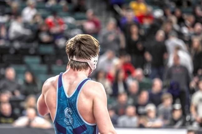 Garret Stewart looks out at the crowd as he finishes his final wrestling match of his career.