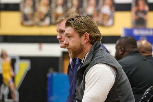 Assistant coaches Daniel Trappe and John Procoppio watch their Spartan wrestle for a spot at States.