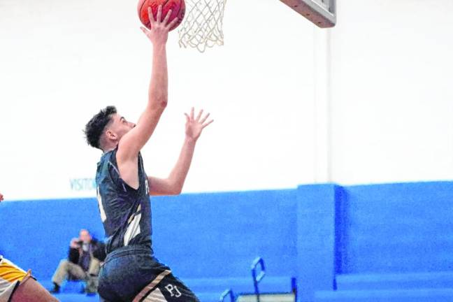 Pope John's Alex Grubbs takes the ball toward the hoop. He scored nine points.