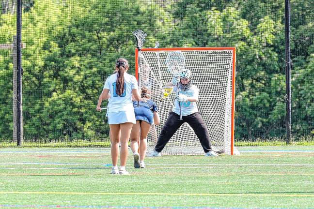 Photos: Spartans in Group 2 final Amelia Eichman of Mendham gets set for a face-off against Sparta goalie Callie Maines.