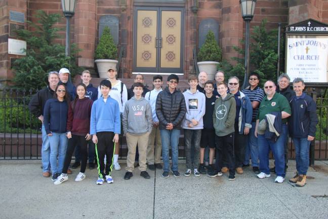 Squires, Roses, and parents stand in front of the historic Saint John&#x2019;s Church and Food Pantry following their morning service project. (Photos submitted)