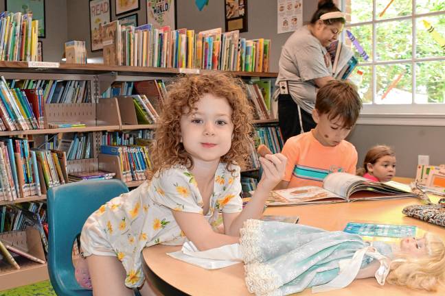 Sparta. Summer Reading Program begins SPL2 Ruby Page, 5, holds a hot dog at a table in the library. (Photo by Maria Kovic)