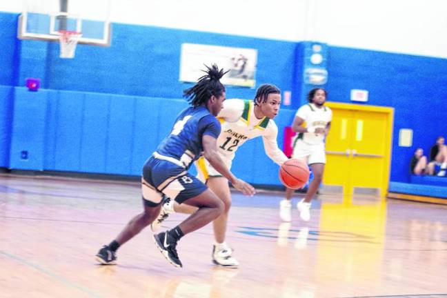 University Academy's Zaire Cross handles the ball while covered by Pope John's Prince Joshua. Cross scored 23 points.