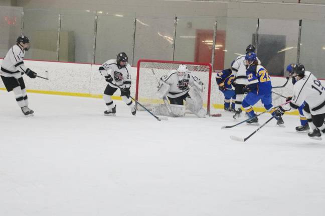 Kinnelon/Jefferson/Sparta United's Aiden Parlapiano (21) moves the puck away from the goal.