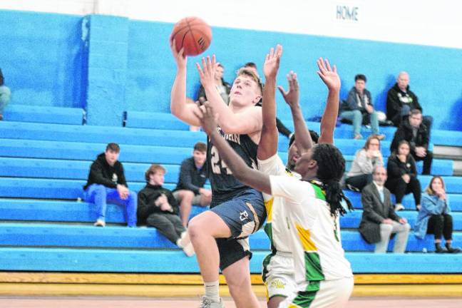 Pope John's Tyler Houser leaps in the second half of the game against University Academy Charter High School on Thursday, Feb. 15. The Lions won, 58-46. (Photos by George Leroy Hunter)