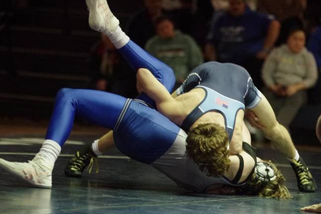 A Spartan, top, and a Kittatinny Cougar grapple on the mat.