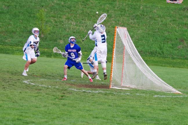 Spartans top Blue devils in boys lacrosse McCall leaps to intercept the ball on a shot from Westfield's Devon McLane.